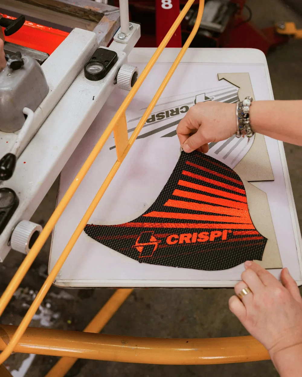 Operator ridicând piesă serigrafiat Crispi de pe platou - Antel Print